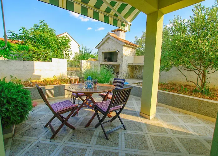 House With Garden And Barbecue Grill In