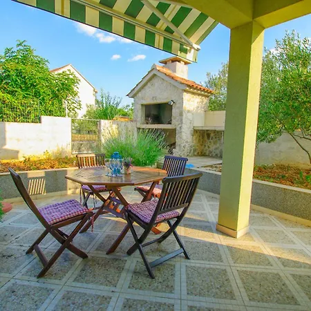 House With Garden And Barbecue Grill In